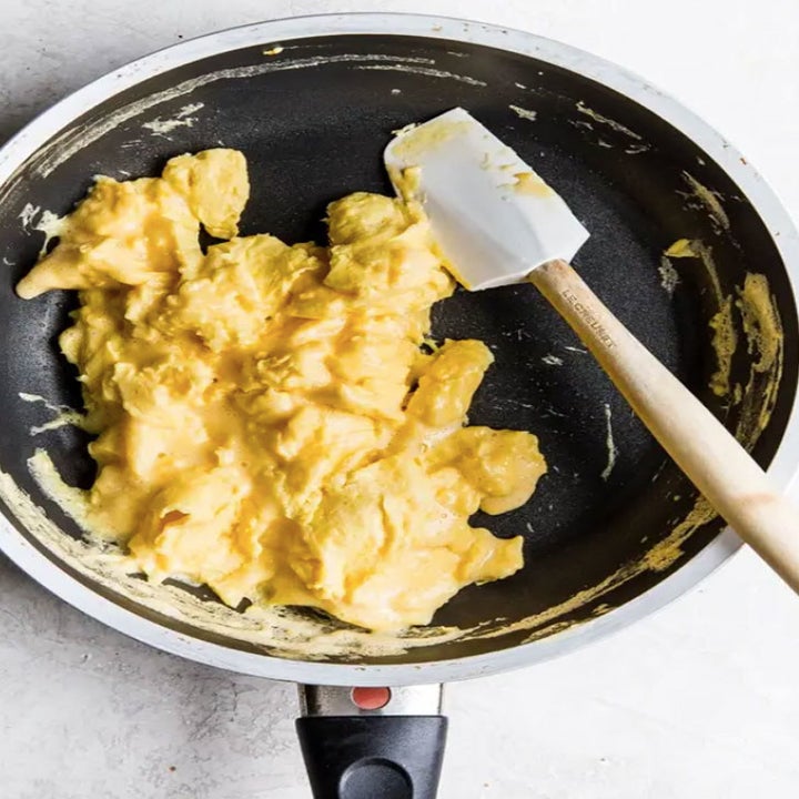 Scrambled eggs cooking in a nonstick skillet.