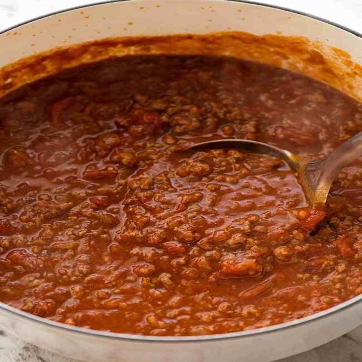 Bolognese sauce simmering in a pot.