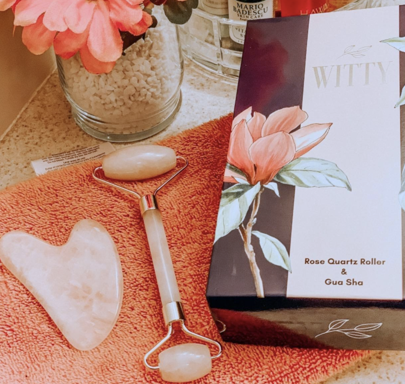 Reviewer image of the roller and gua sha tools laid out on a vanity