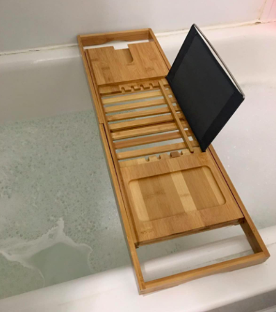 reviewer photo showing bamboo tub caddy with an iPad propped on it 