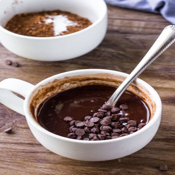 Chocolate batter and chocolate chips in a mug.