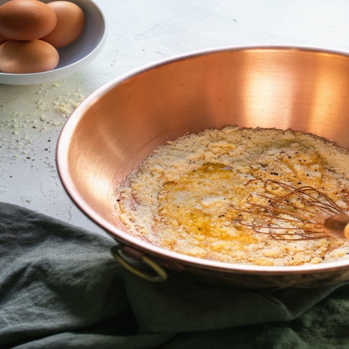 Whisking together the creamy Parmesan and egg Carbonara sauce.