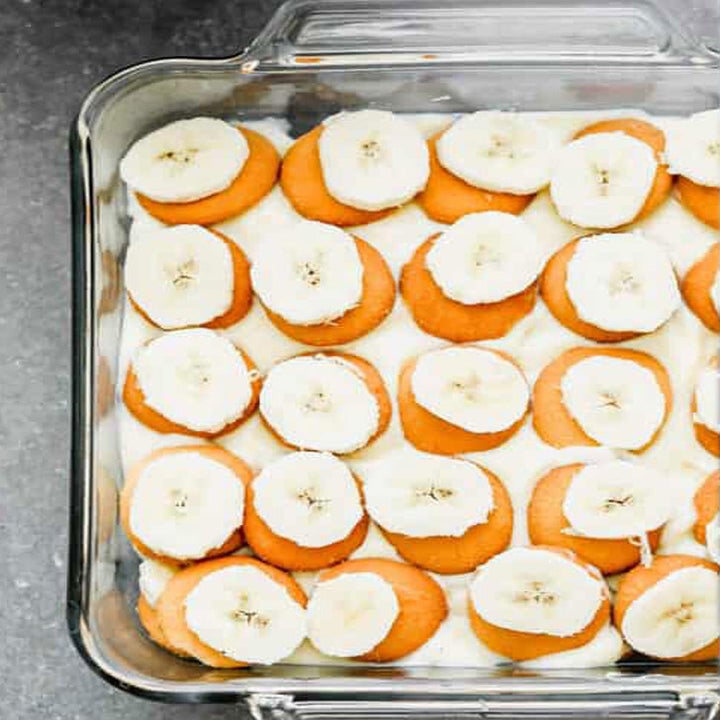 Egg custard, vanilla wafers, and sliced bananas in a baking dish.