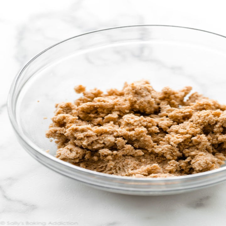 Peanut butter cookie crust in a glass bowl.