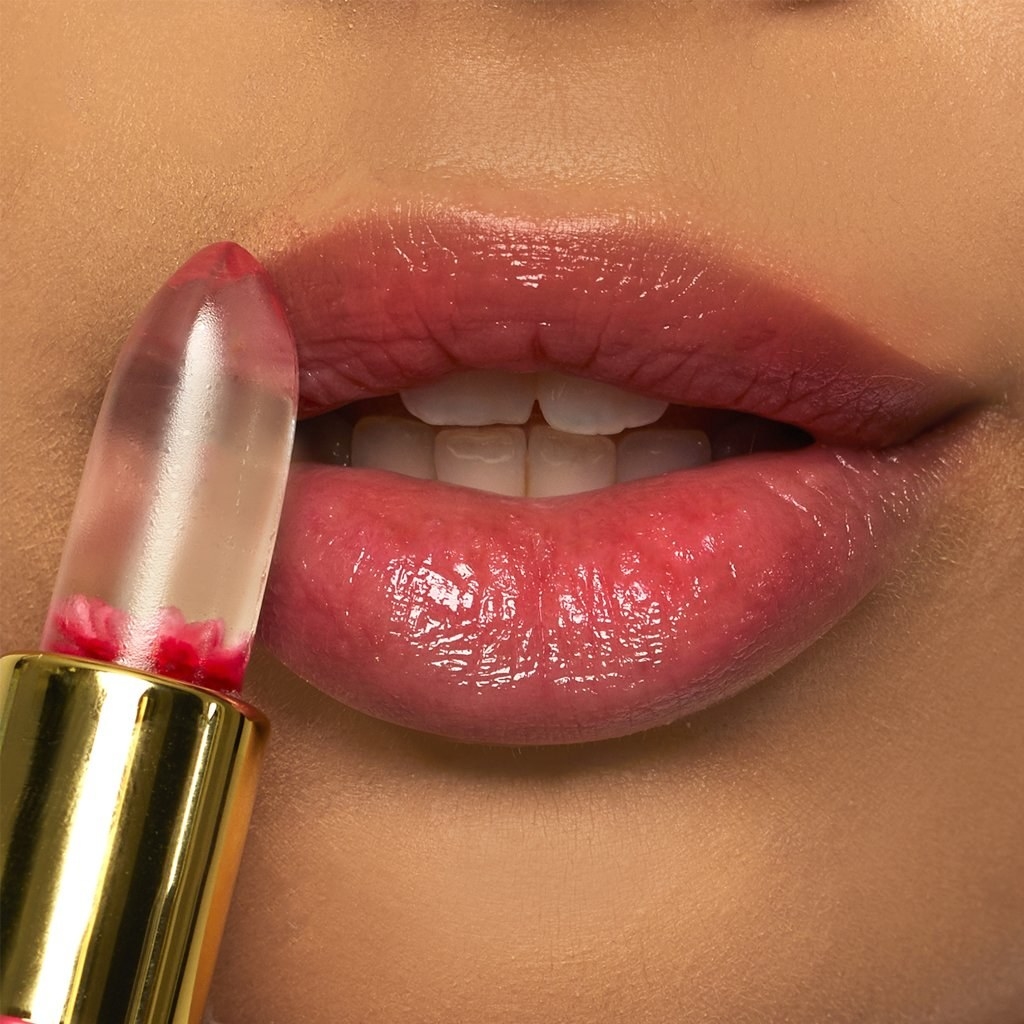 Model applies Winky Lux Color Changing Lipstick to lips