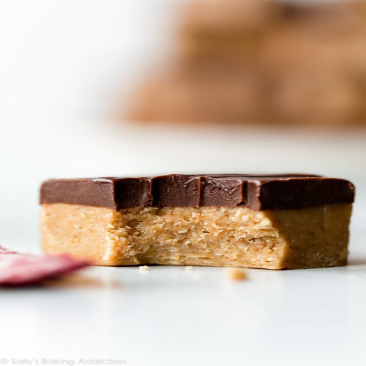 A peanut butter chocolate cookie with a bite missing.