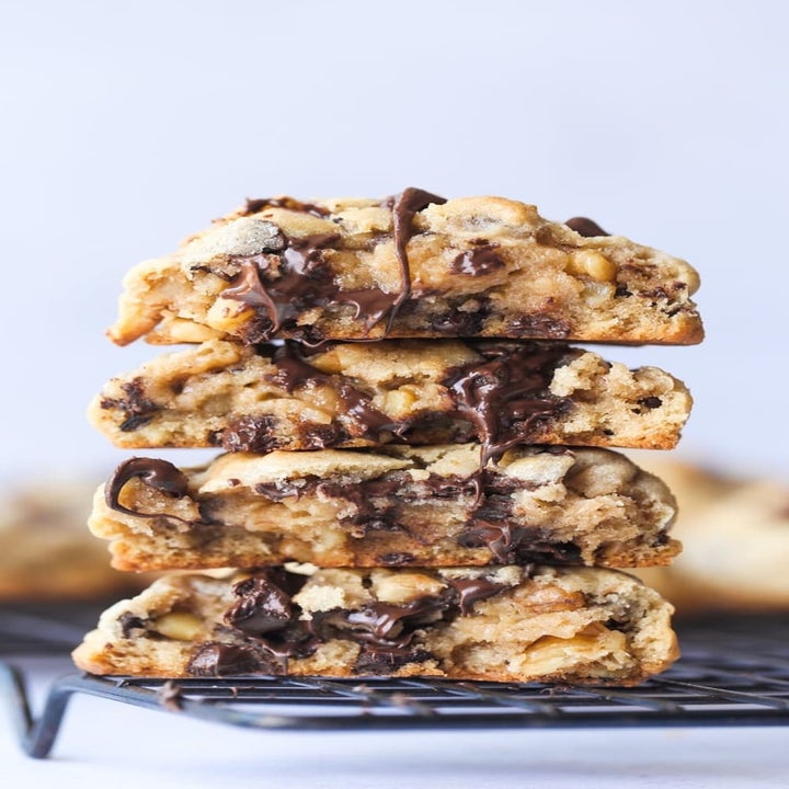A stack of chocolate chip walnut cookies sliced in half.