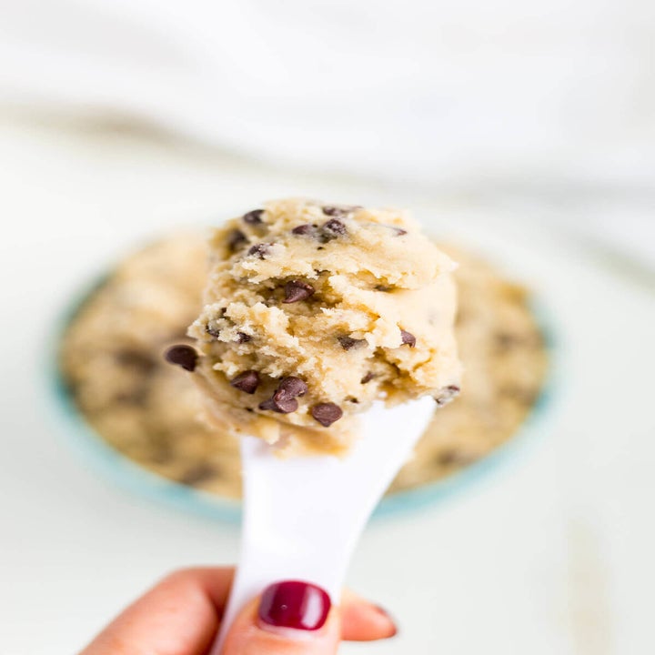 A spoonful of cookie dough with chocolate chips.