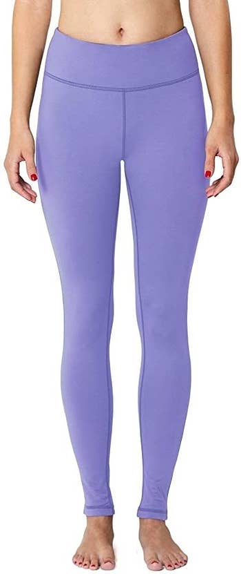 A model wearing the leggings in paisley purple