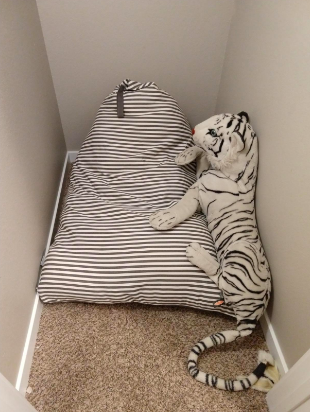 Same closet with nothing on floor, all clothes put inside chair 