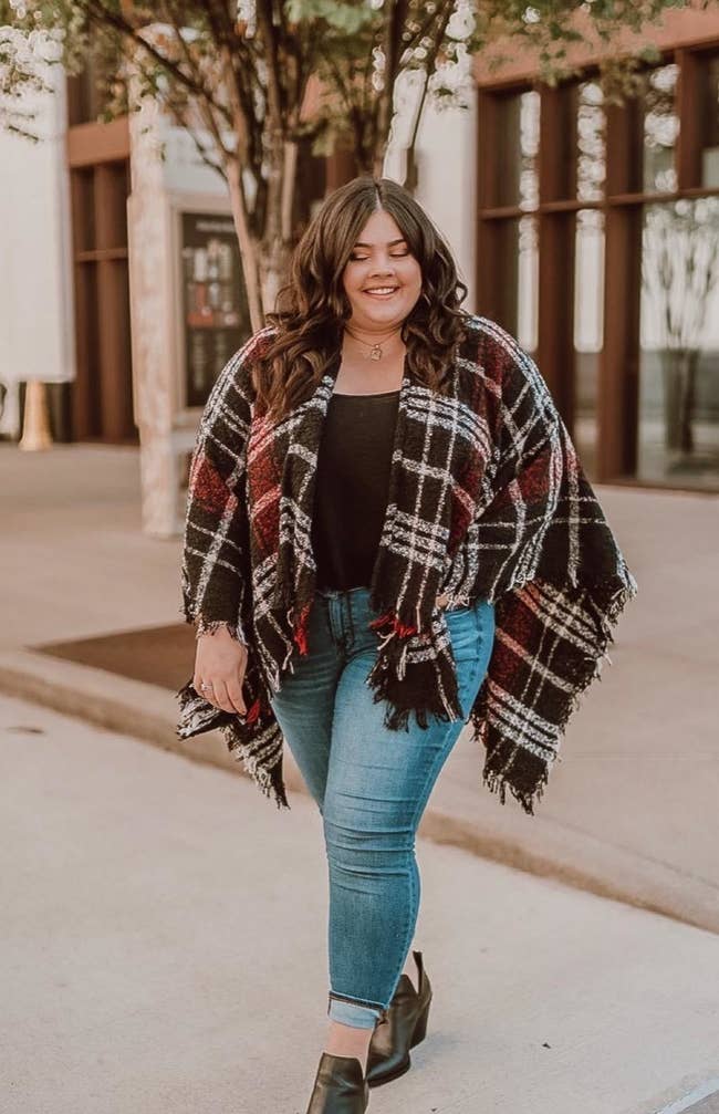 Reviewer wearing the black/red/white buffalo plaid poncho