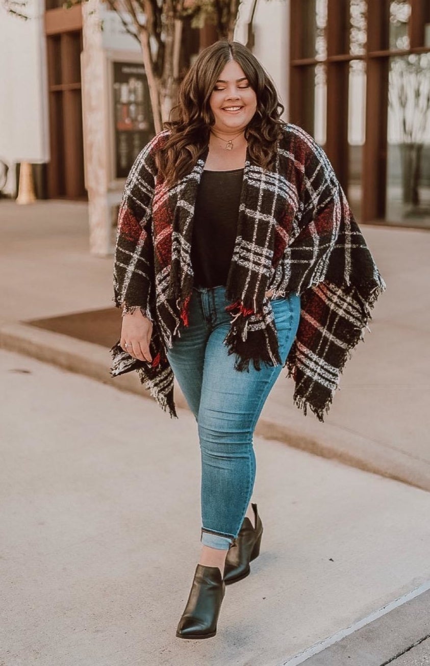 Reviewer wearing the black/red/white buffalo plaid poncho