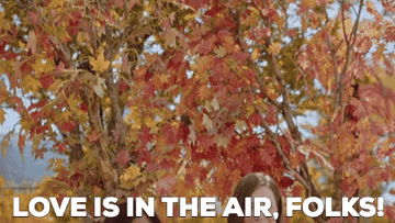 A GIF of a woman saying, &quot;Love is in the air&quot;