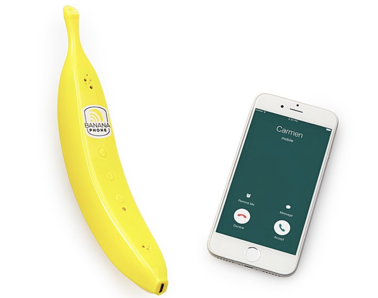 Cellphone next to a plastic banana with small buttons and speakers