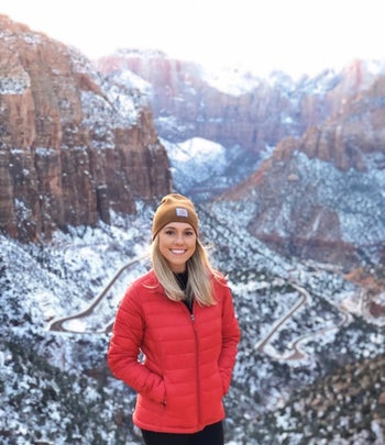 A different reviewer wearing the puffer in bright red