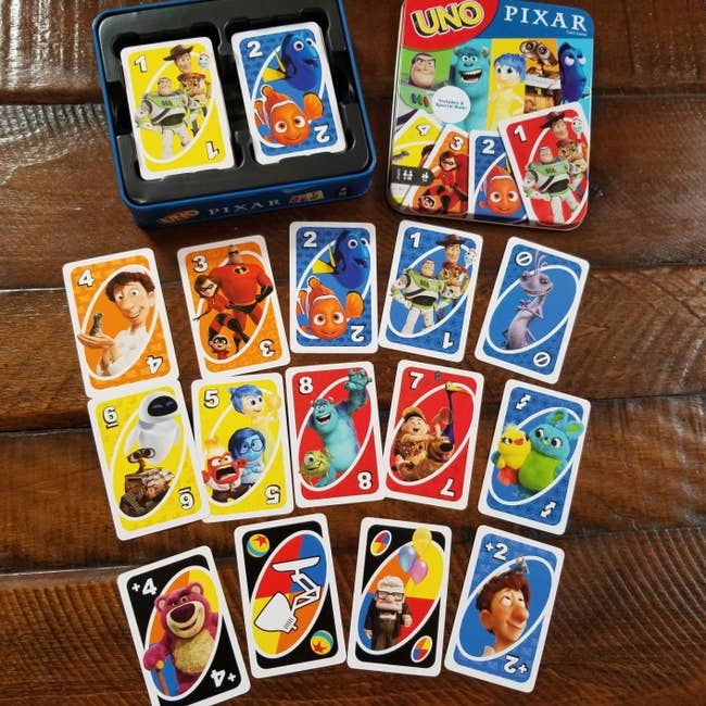 deck of uno cards with characters from ratatouille, finding nemo, the incredibles, up, toy story, and more