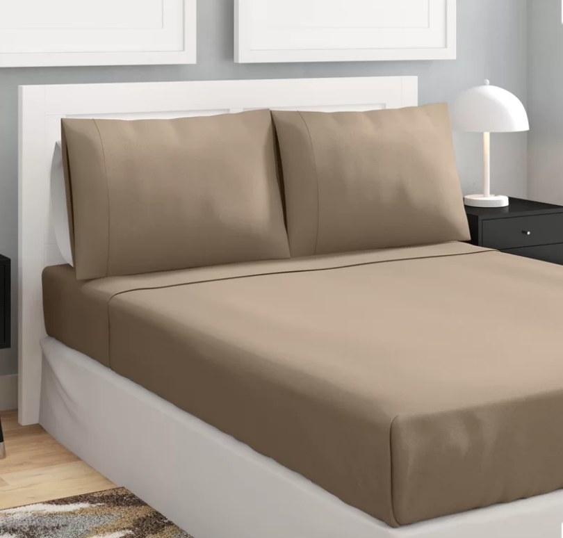 Set of taupe sheets and pillows on full size bed