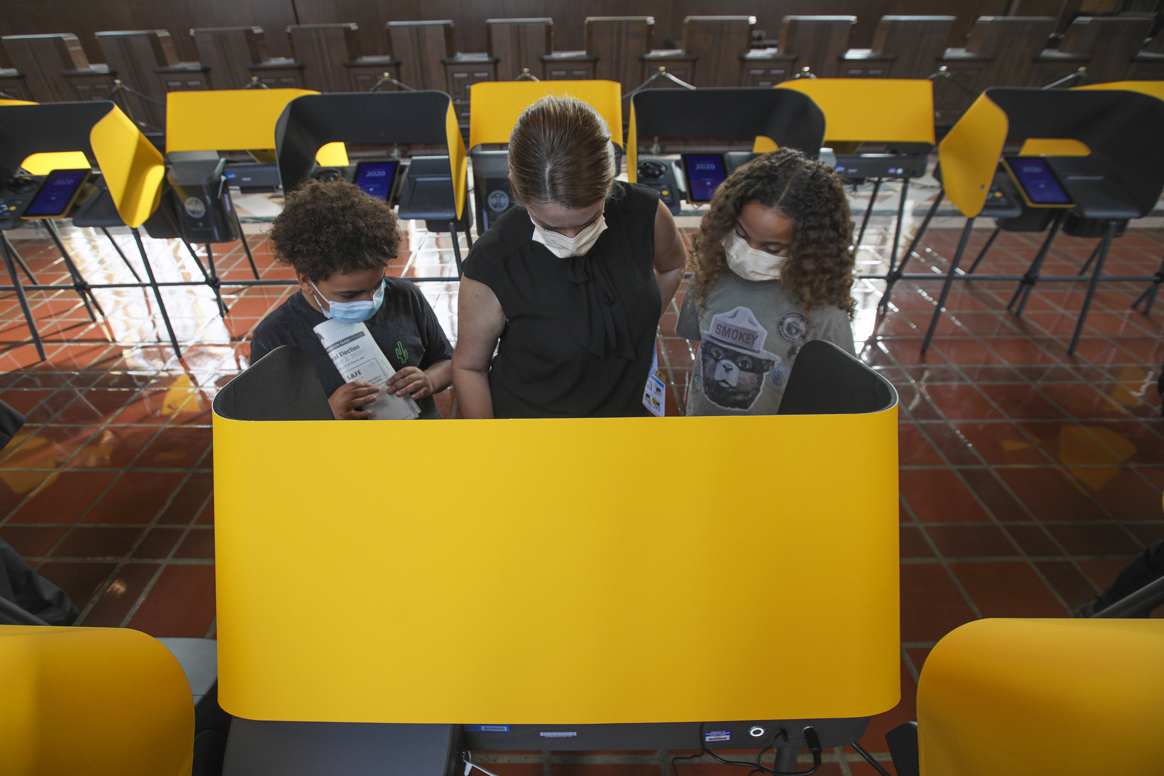 Mother and two children at a polling station. 