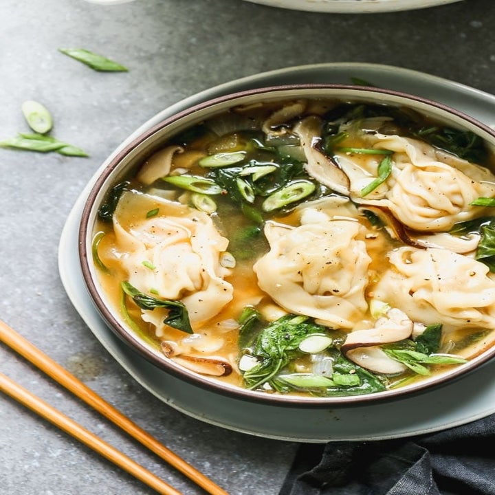 Homemade wonton soup with scallions.