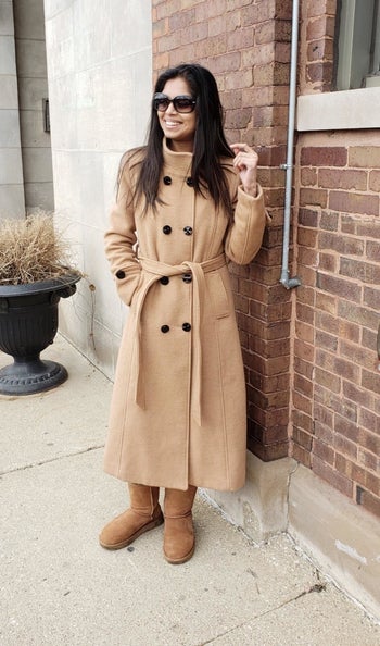 A reviewer wearing the coat in tan