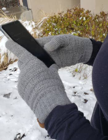 Another reviewer wearing the grey gloves showing them in use using an iPhone