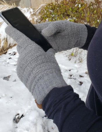 Another reviewer wearing the grey gloves showing them in use using an iPhone