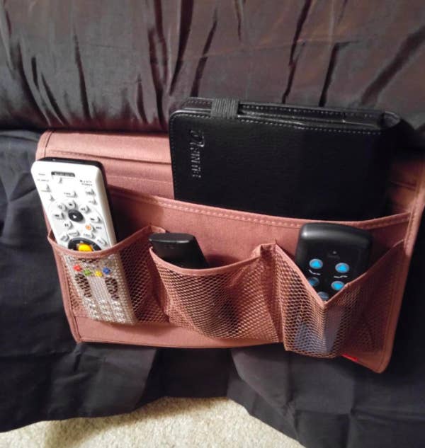 reviewer photo showing pink bedside caddy with remotes and iPad in it