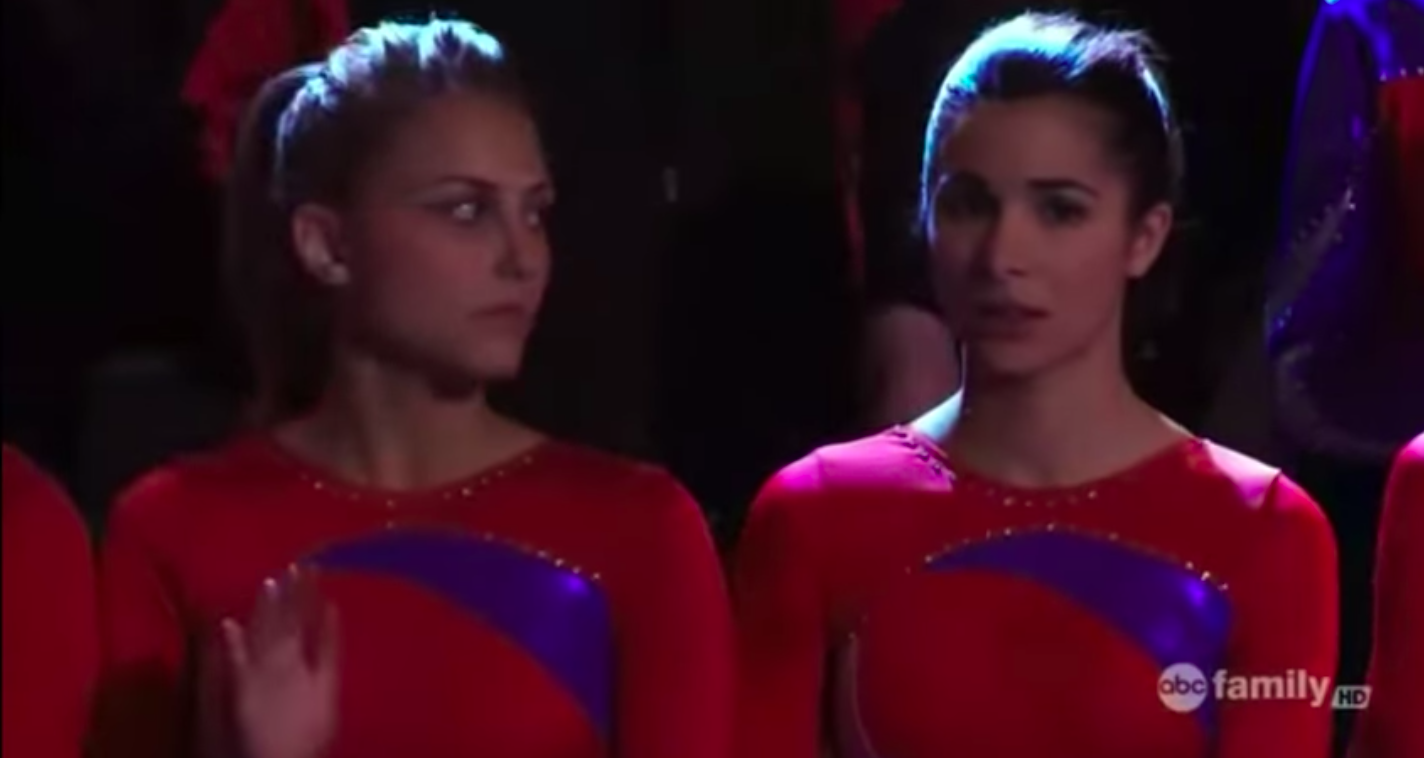 Two dancers on a team standing next to each other