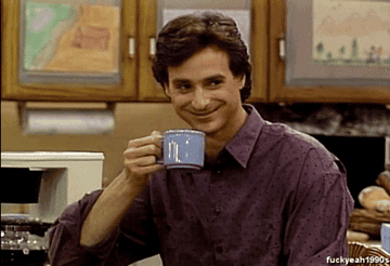 Danny Tanner smirking while holding a cup of coffee.