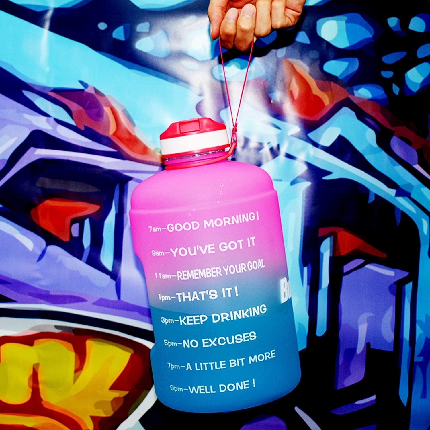 Ombre pink and blue motivational water bottle with time marks and phrases that say &quot;Remember Your Goal&quot; and &quot;A Little Bit More&quot;