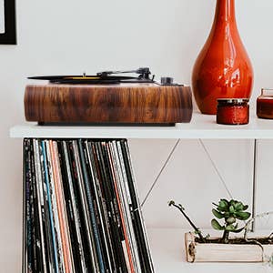 The record player styled on a shelf with records