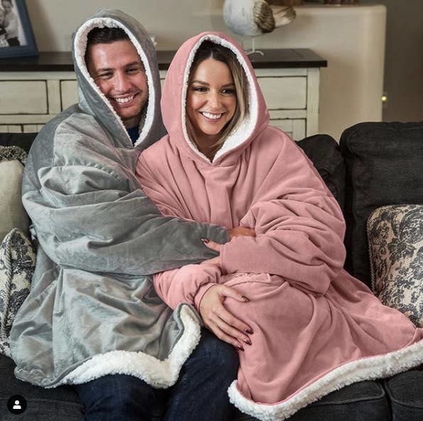 Two people snuggling in the blankets