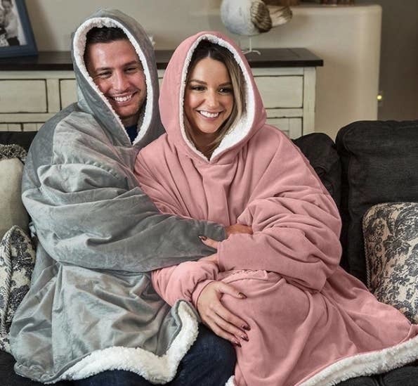 Two people snuggling in the blankets