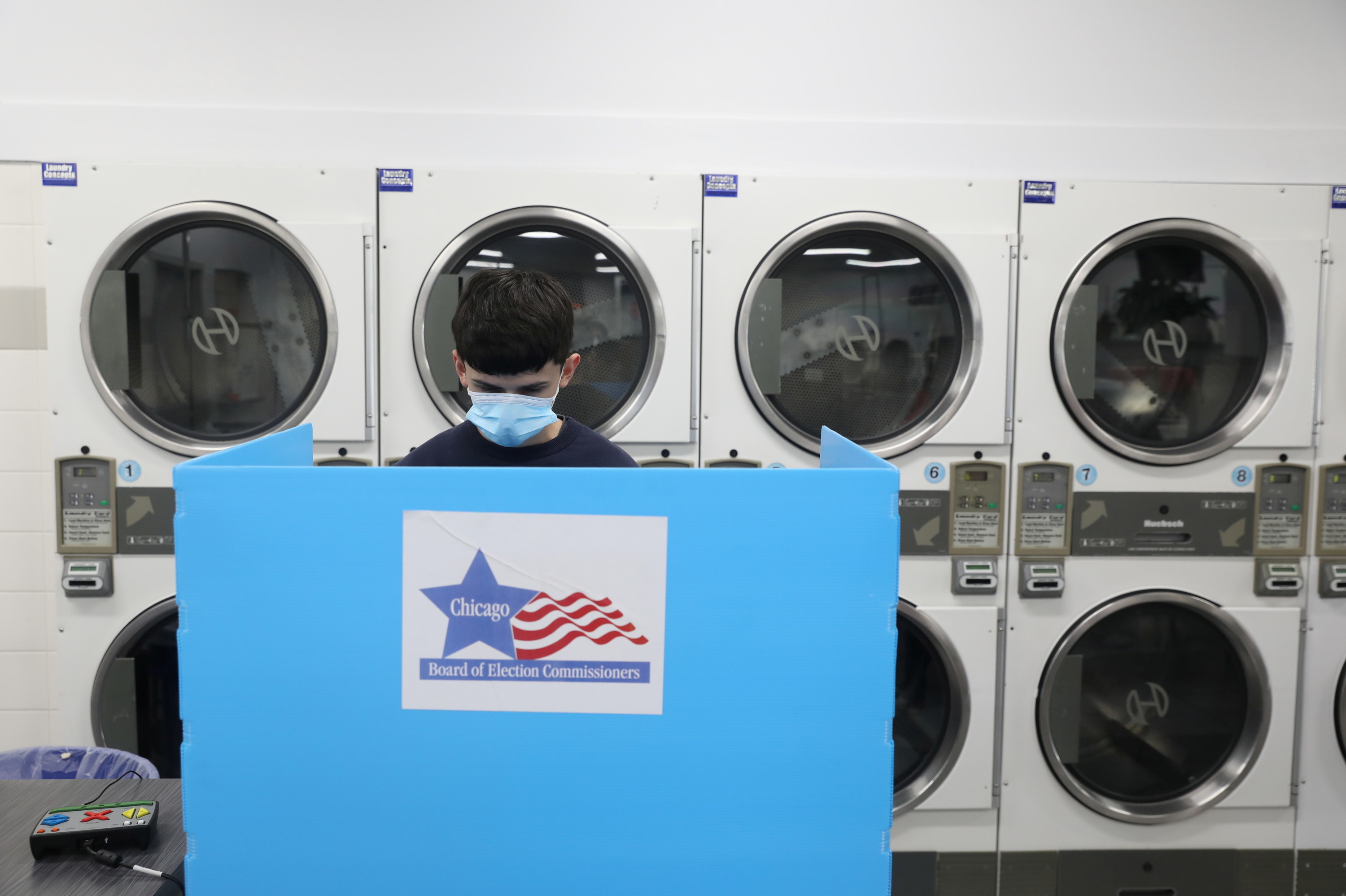 Man voting at a laundromat. 