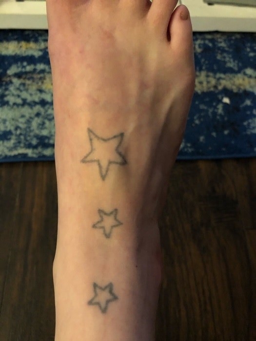 Three star outline tattoos that run up the top of someone&#x27;s right foot