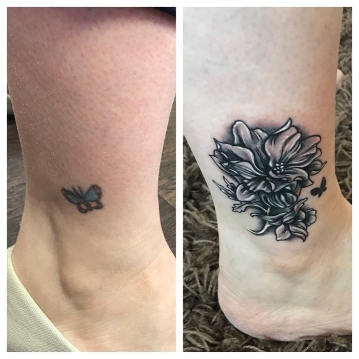 A tiny butterfly tattoo on someone&#x27;s ankle, then covered by a large flower with a small, black butterfly silhouette tattoo next to it