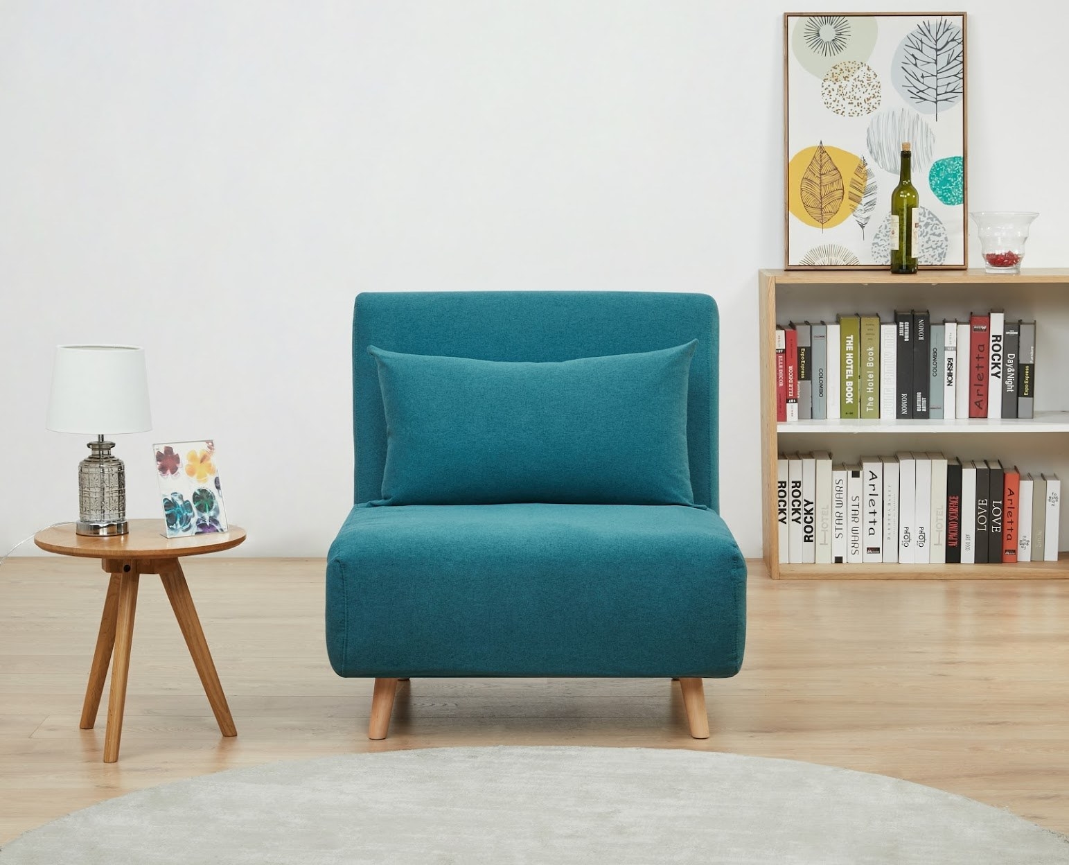 teal fabric chair with wooden legs and toss pillow
