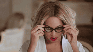 Beyoncé seductively taking off her reading glasses at the dining room table in the music video for &#x27;Jealous&#x27;