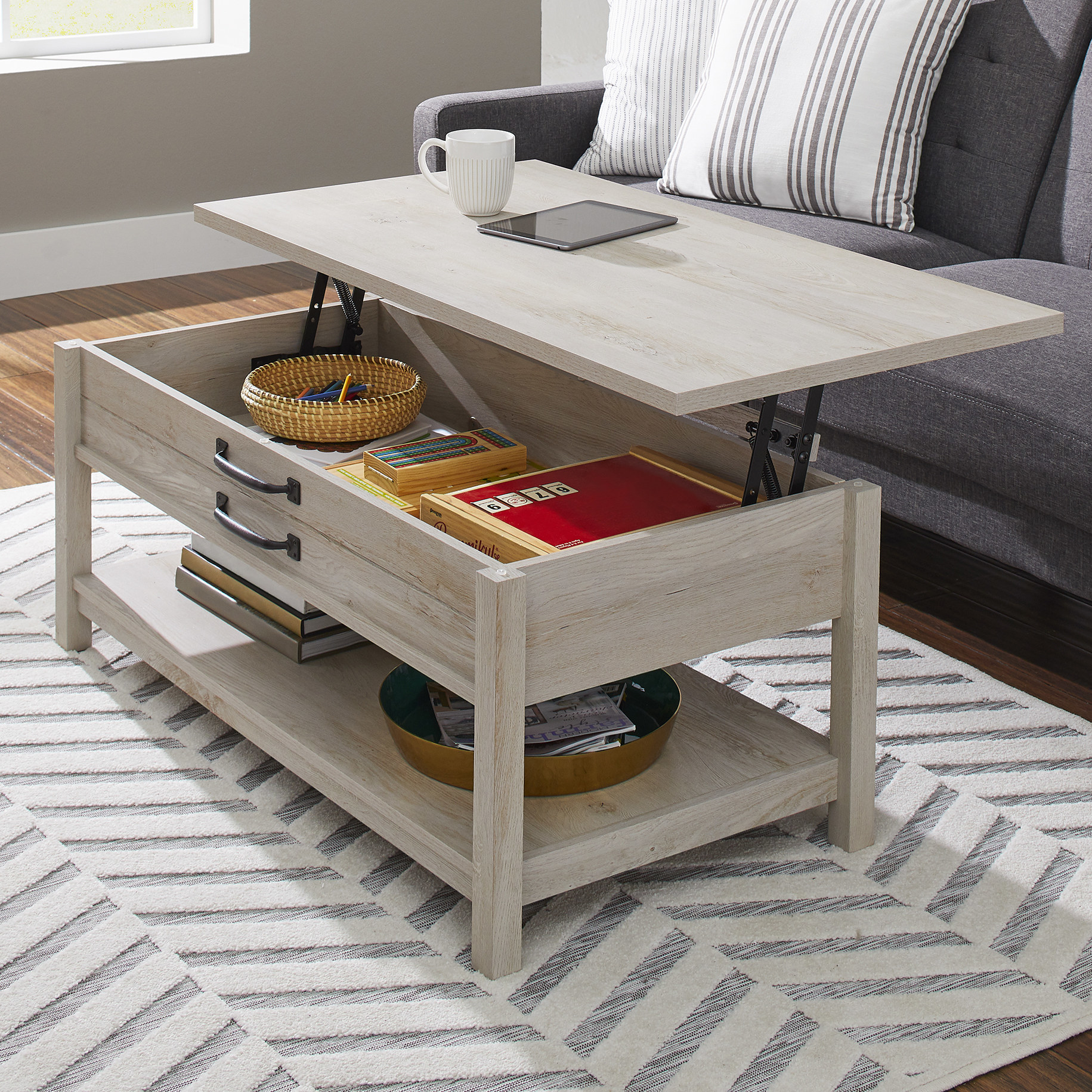 Farmhouse style coffee table with top lifted and miscellaneous products inside
