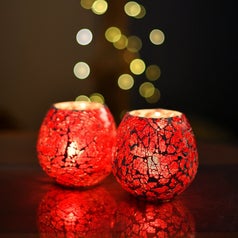 A pair of red candle holders.