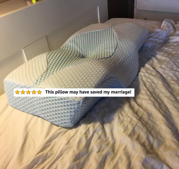 The curved pillow with five stars and text "this pillow may have saved my marriage!"