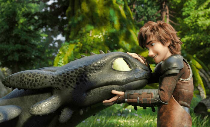 Hiccup cradling Toothless&#x27;s head while they both look at each other