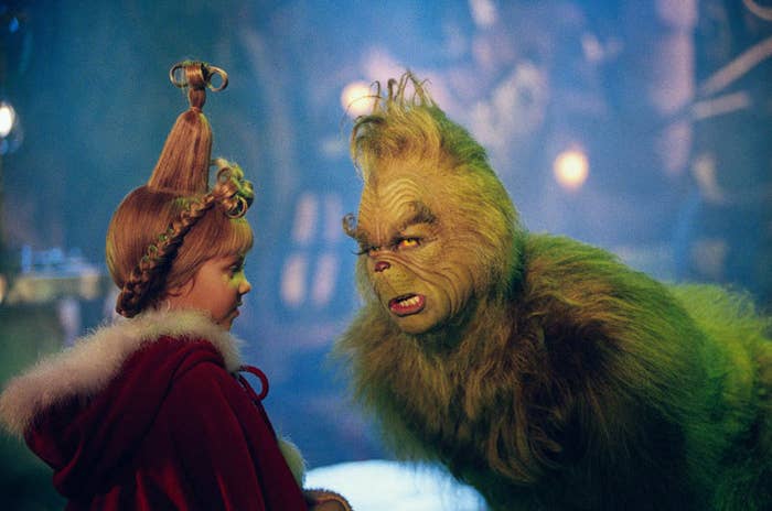 The Grinch bending down and looking at Cindy Lou