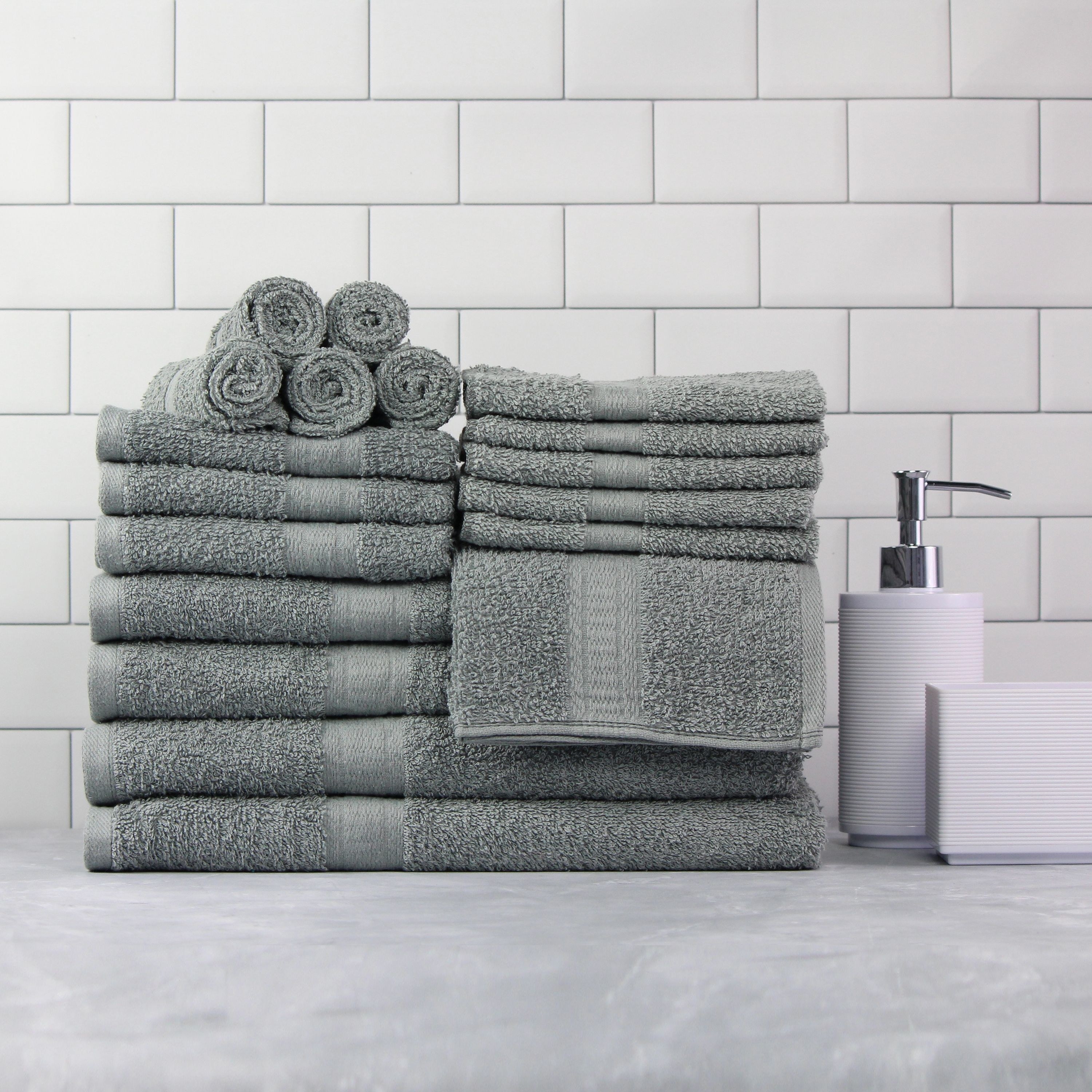 gray bath towels folded up on a bathroom coutner