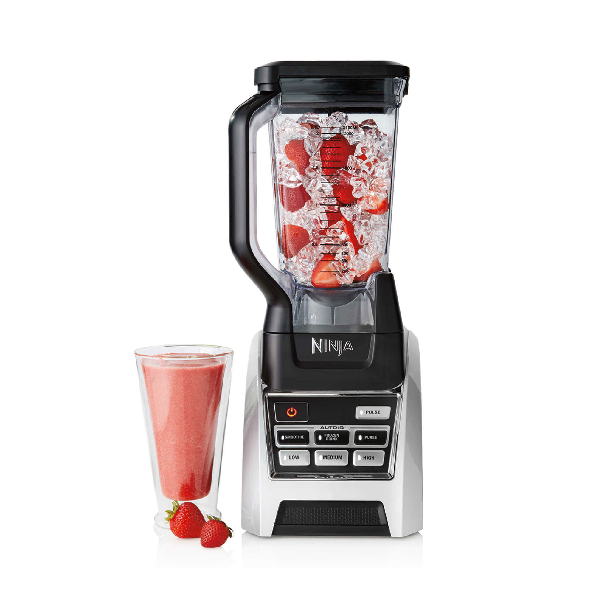 ninja blender with strawberries and ice in it and a strawberry smoothie next to it