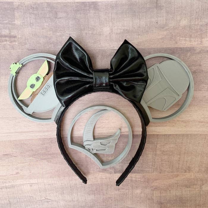 3d printed ears with a baby yoda ear, a mando ear, and a black bow