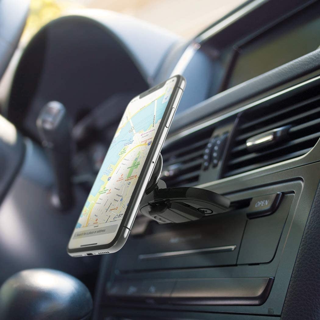 phone mounted to a magnetic holder on a dashboard 