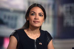 AOC smiling at a press event