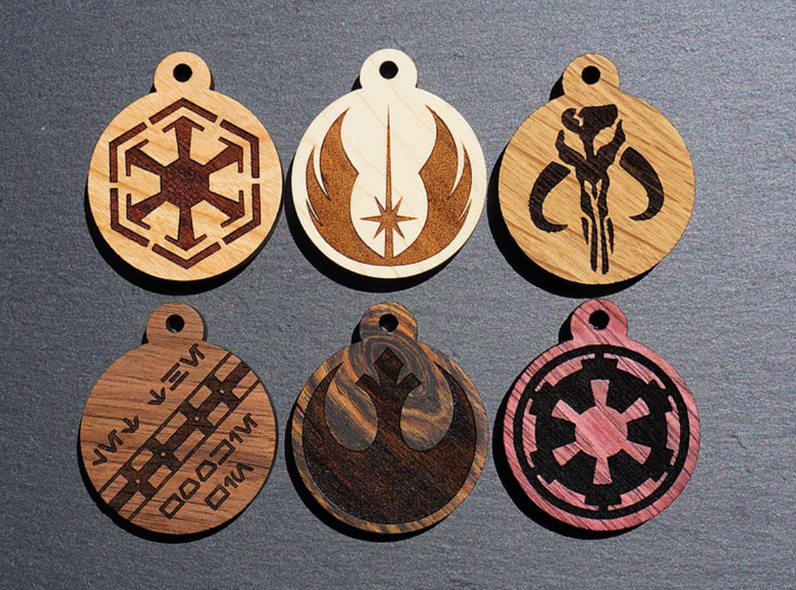 six different wooden tags with different star wars icons on them