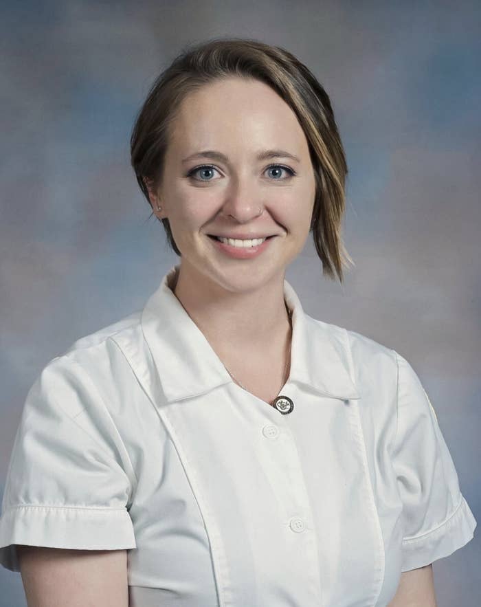 Kathryn smiling for a professional photo in a pressed, white shirt with natural makeup and her hair done.